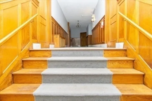 a view of staircase with large trees