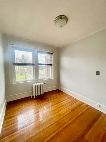 a view of a room with wooden floor