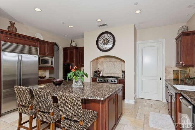 430 Sereno Place Camarillo, CA 93010 - Photo 12 of 33 a kitchen with stainless steel appliances granite countertop a stove a refrigerator a oven a sink with a dining table and chairs