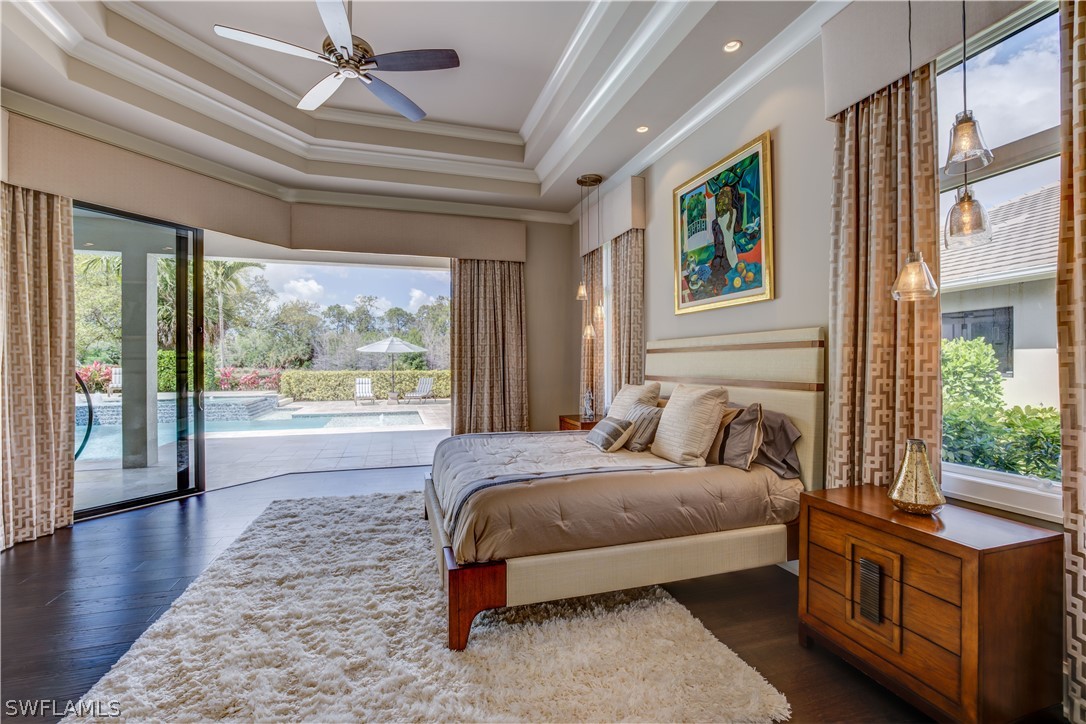 4257 Deephaven Lane Naples, FL 34119 - Photo 13 of 13 a spacious bedroom with a large bed and a large window with the outer view