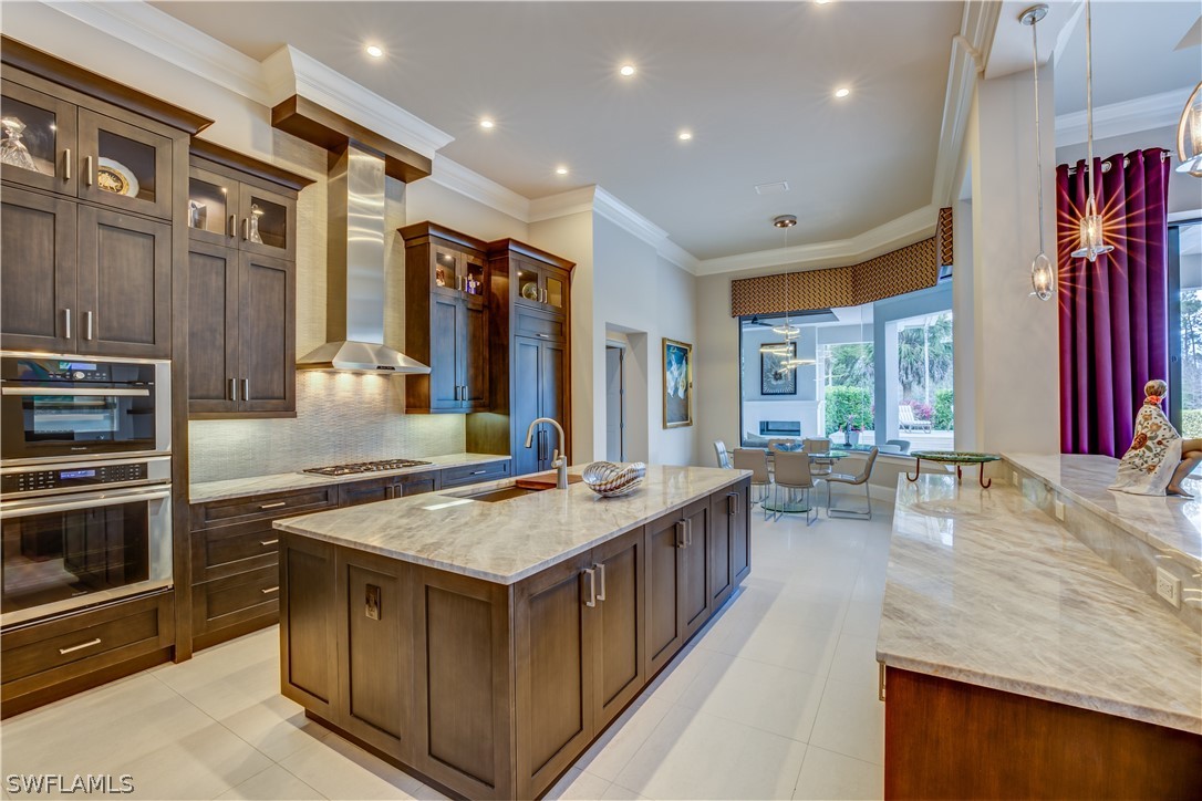 4257 Deephaven Lane Naples, FL 34119 - Photo 7 of 13 a kitchen with sink stove and cabinets