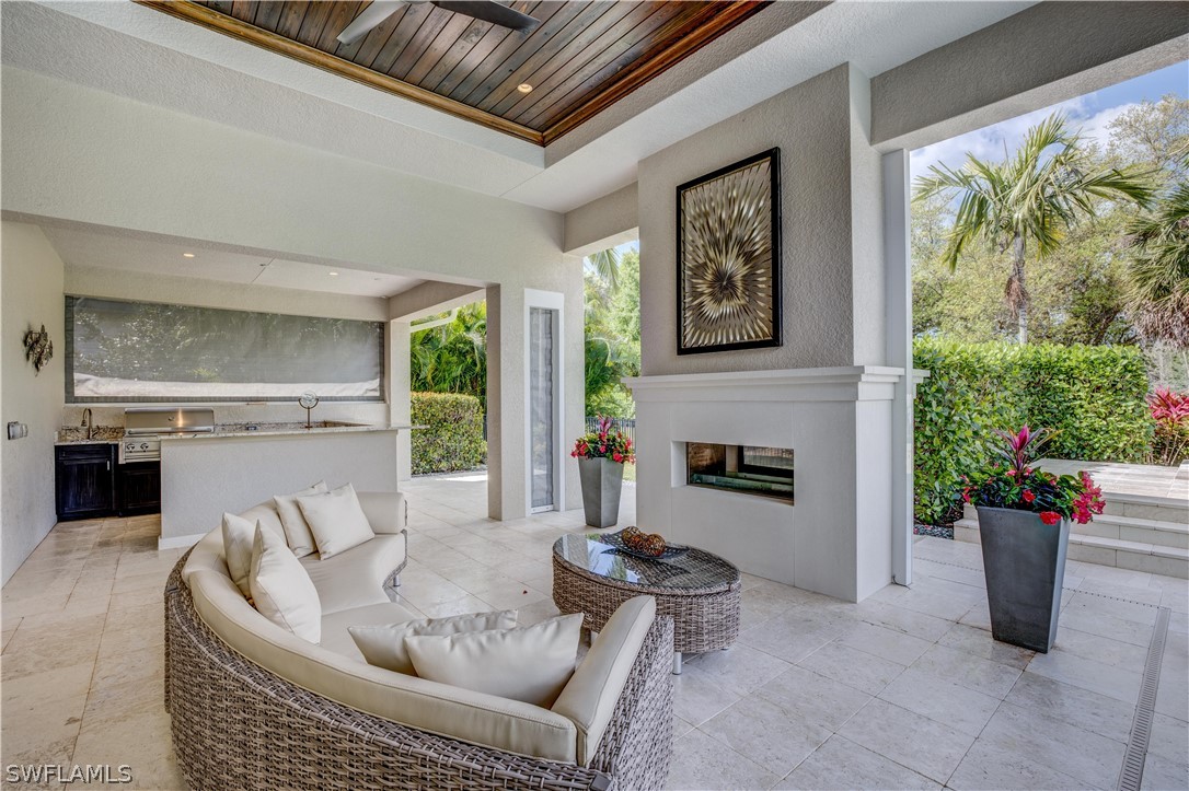 4257 Deephaven Lane Naples, FL 34119 - Photo 9 of 13 a living room with furniture and a fireplace