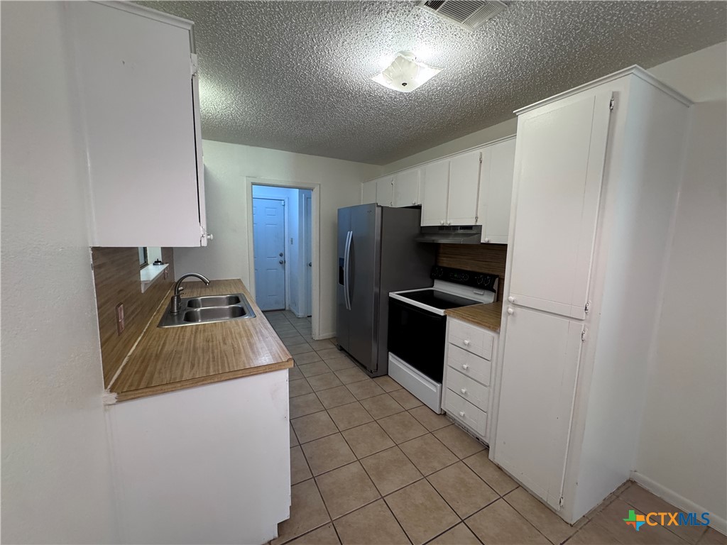 1301 North 10th Street Temple, TX 76501 - Photo 7 of 25 a kitchen with a refrigerator sink and stove