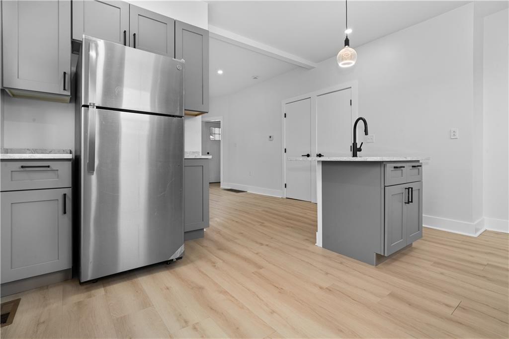 309 North Mathilda Street Pittsburgh, PA 15224 - Photo 12 of 30 a kitchen with stainless steel appliances a refrigerator and a sink