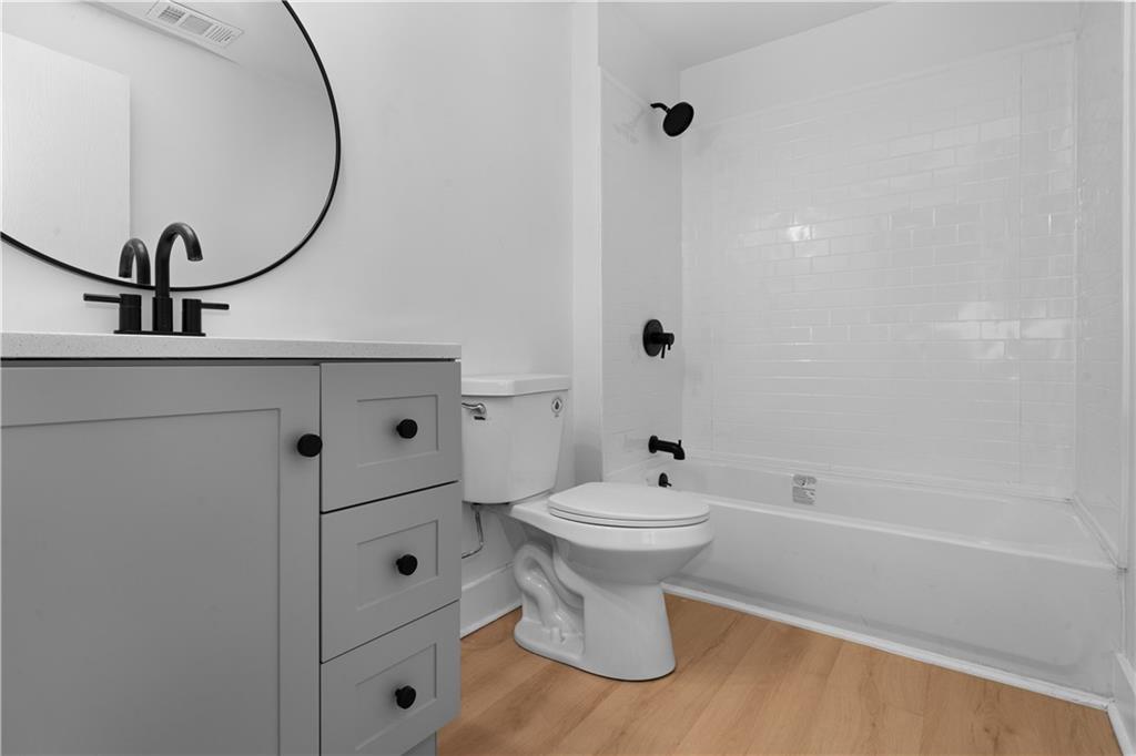 309 North Mathilda Street Pittsburgh, PA 15224 - Photo 19 of 30 a bathroom with a toilet a sink and a mirror