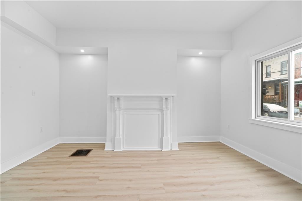 309 North Mathilda Street Pittsburgh, PA 15224 - Photo 6 of 30 a view of a room with wooden floor and cabinet