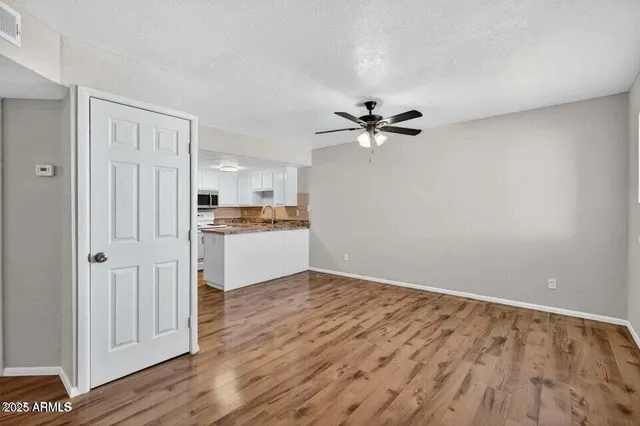 a view of a kitchen with a sink and a refrigerator