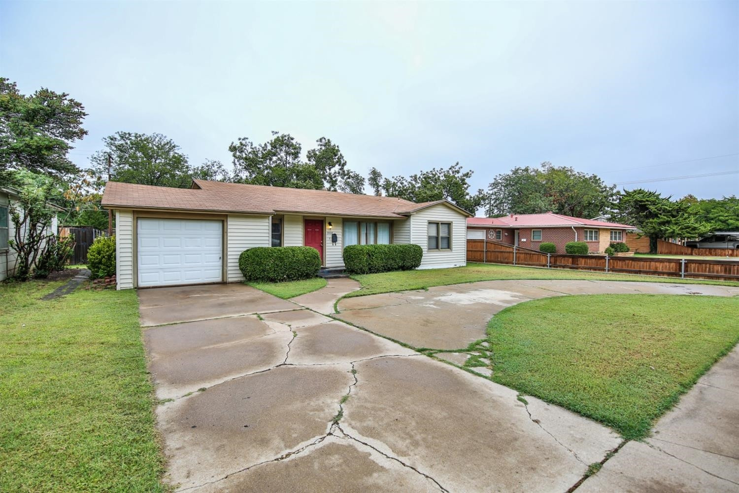 3408 38th Street Lubbock, TX 79413 - Photo 3 of 10 a front view of a house with a garden