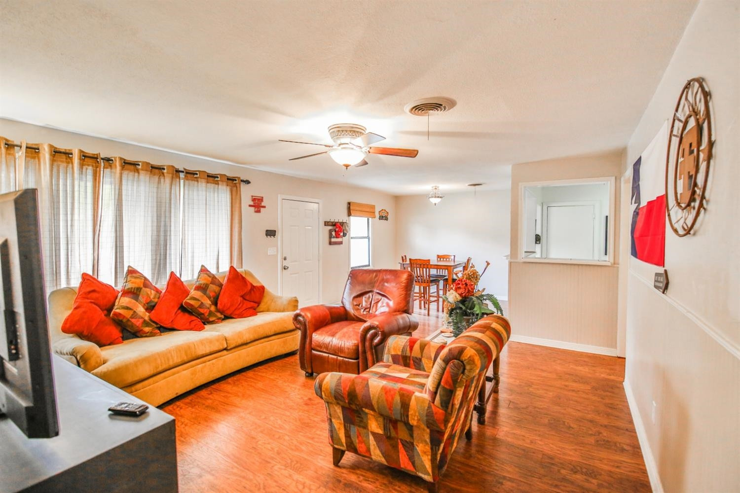 3408 38th Street Lubbock, TX 79413 - Photo 4 of 10 a living room with furniture cabinets and a large window
