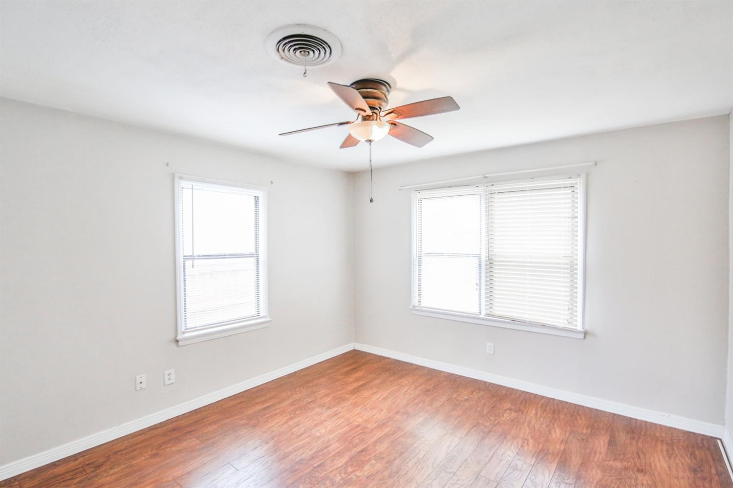 3408 38th Street Lubbock, TX 79413 - Photo 7 of 10 a view of an empty room with a window and a fan