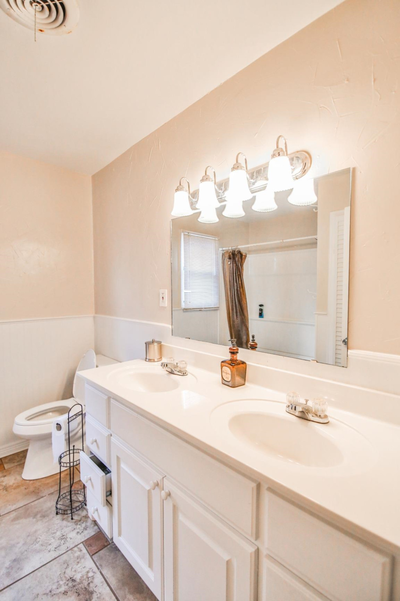 3408 38th Street Lubbock, TX 79413 - Photo 8 of 10 a bathroom with a sink and a mirror