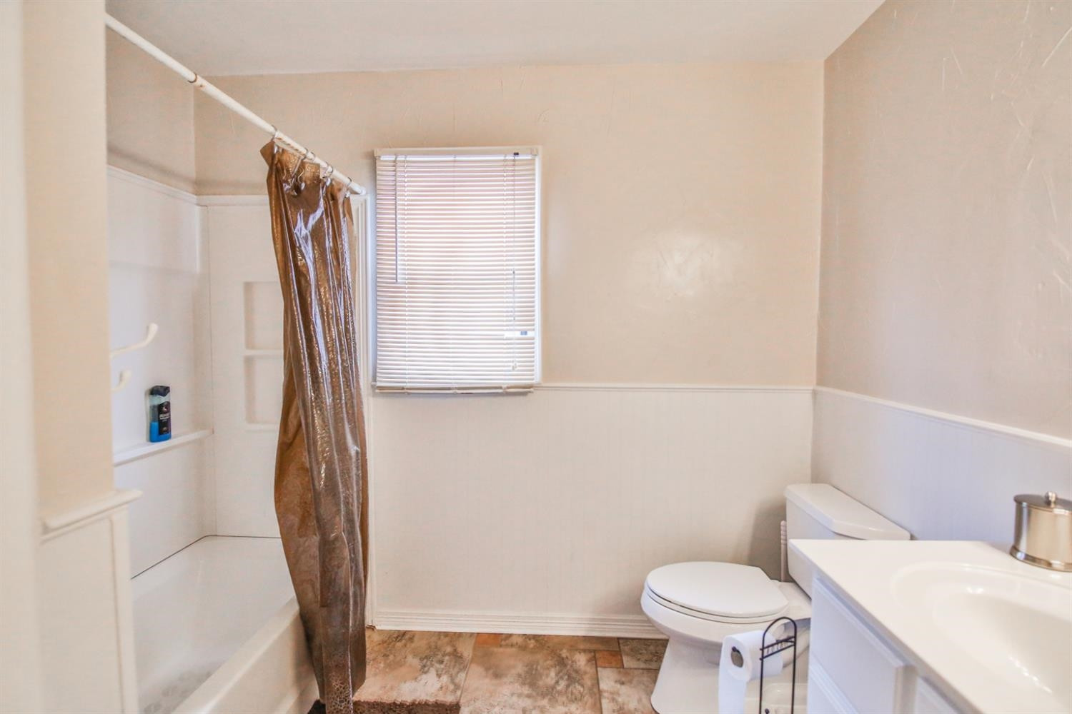 3408 38th Street Lubbock, TX 79413 - Photo 9 of 10 a bathroom with a sink toilet and shower