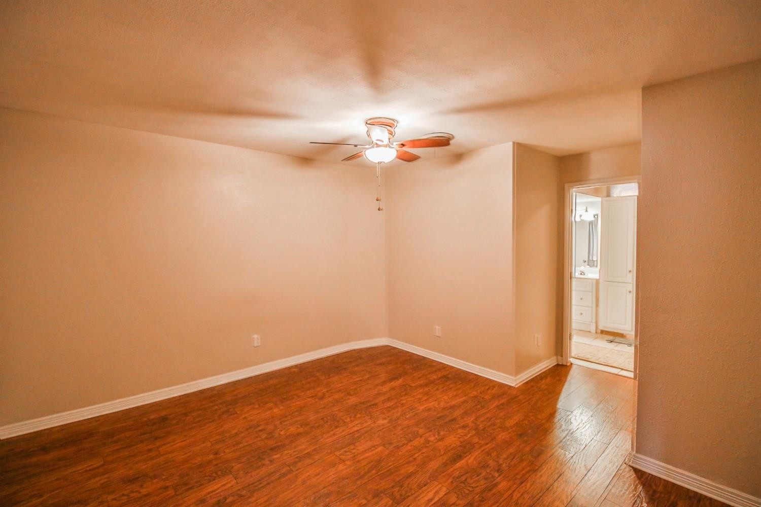 3408 38th Street Lubbock, TX 79413 - Photo 10 of 10 a view of a room with wooden floor and a ceiling fan