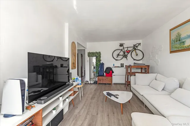 a view of entryway with furniture and wooden floor