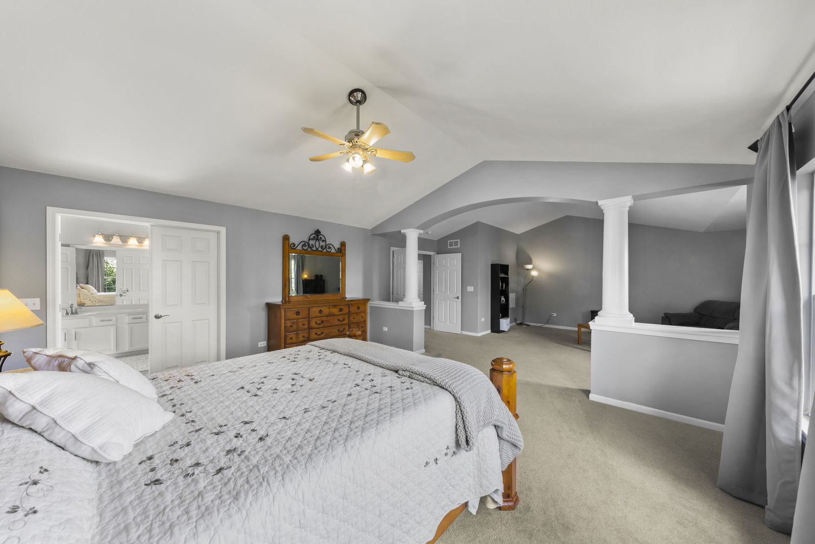 26210 Mapleview Drive Plainfield, IL 60585 - Photo 18 of 55 a bedroom with a large bed and a chandelier