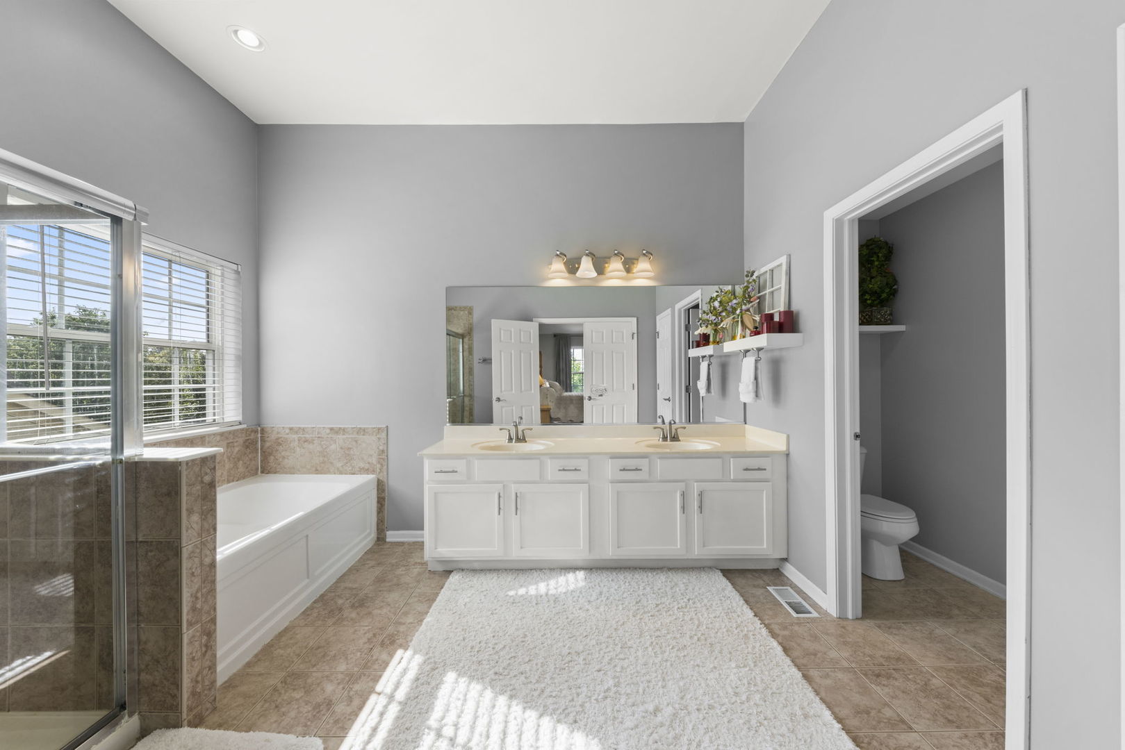 26210 Mapleview Drive Plainfield, IL 60585 - Photo 21 of 55 a bathroom with a tub sink and mirror