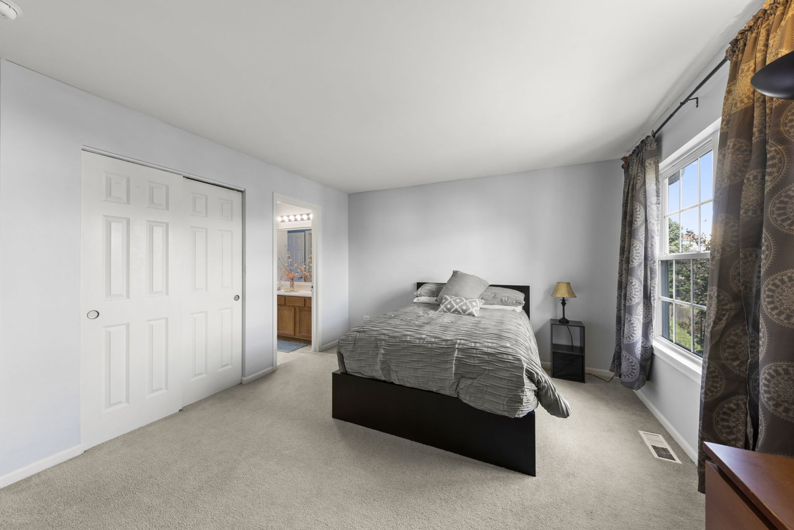 26210 Mapleview Drive Plainfield, IL 60585 - Photo 28 of 55 a bedroom with a bed lamp and a large window