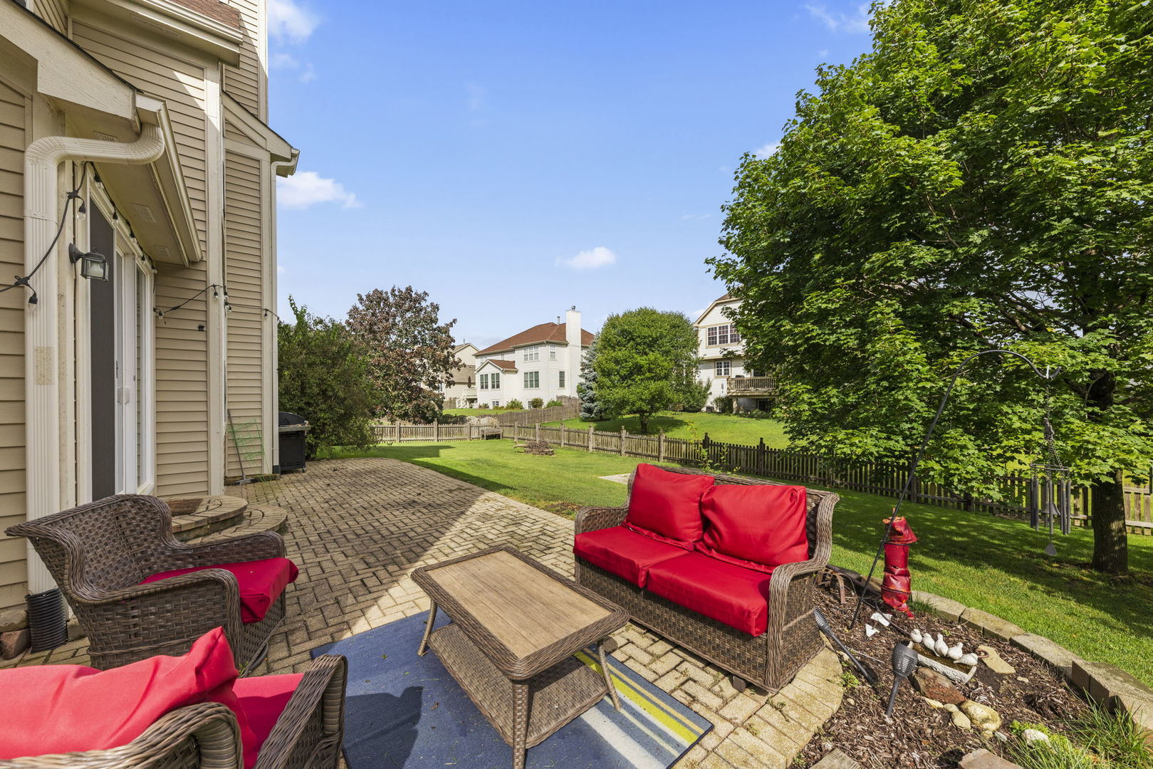 26210 Mapleview Drive Plainfield, IL 60585 - Photo 40 of 55 a view of a patio with couches table and chairs and potted plants