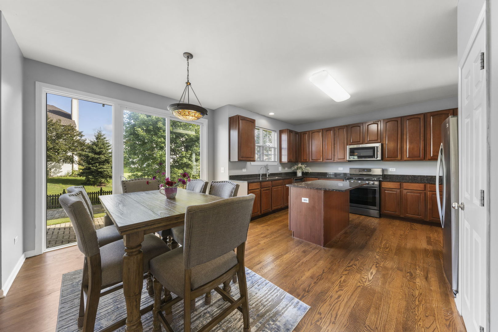 26210 Mapleview Drive Plainfield, IL 60585 - Photo 9 of 55 a view of a dining room with furniture window and wooden floor