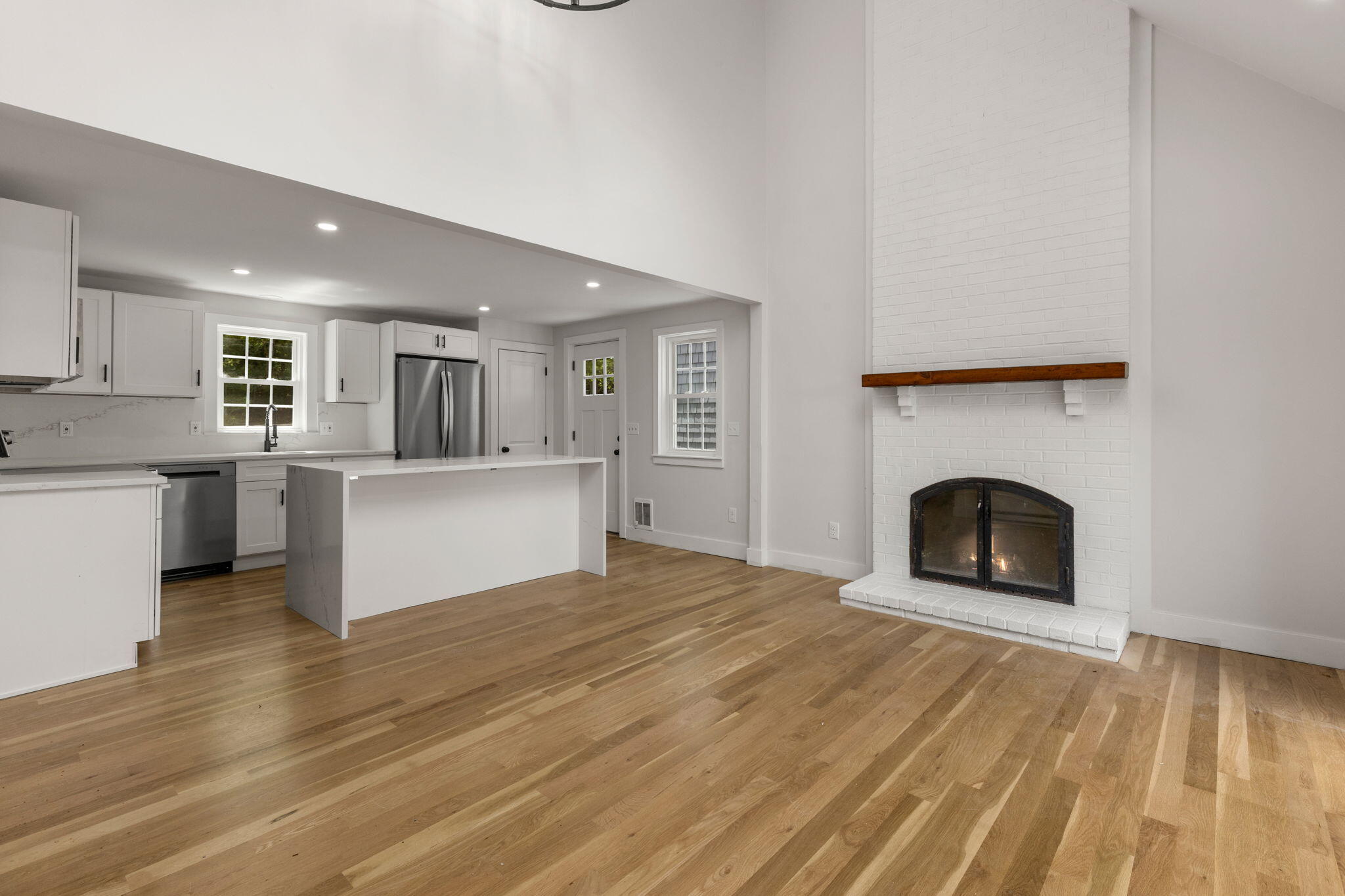 81 Sam Turner Road East Falmouth, MA 02536 - Photo 16 of 37 a view of a kitchen and an empty room with a fireplace