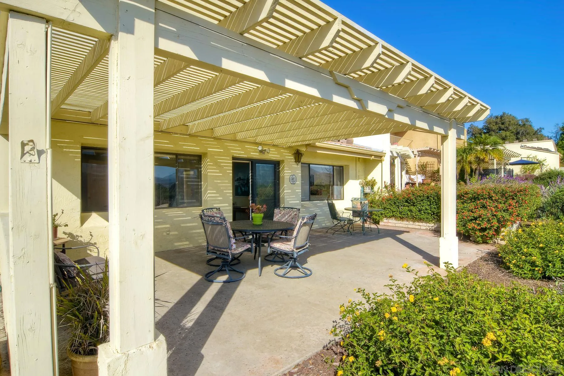 13416 The Square Poway, CA 92064 - Photo 11 of 35 a view of a patio with table and chairs and potted plants