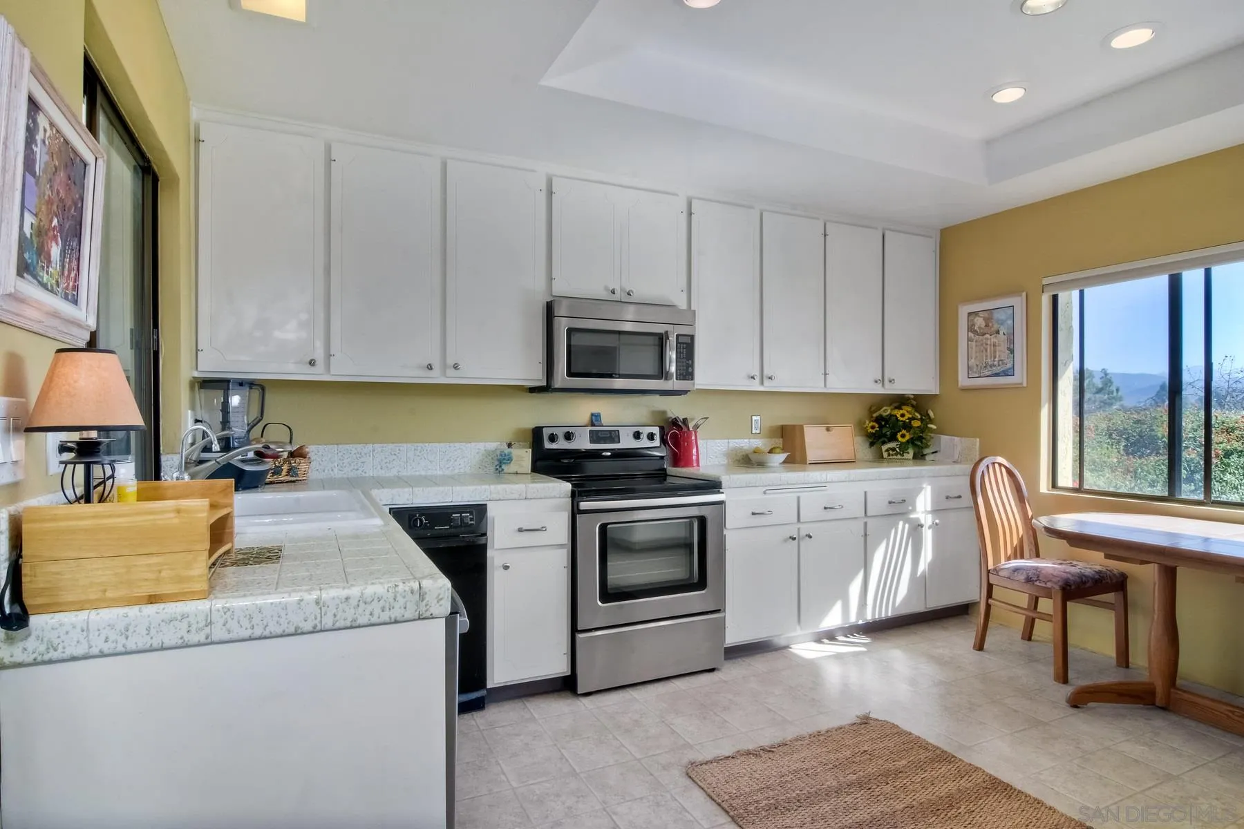 13416 The Square Poway, CA 92064 - Photo 18 of 35 a kitchen with granite countertop cabinets stainless steel appliances and a window