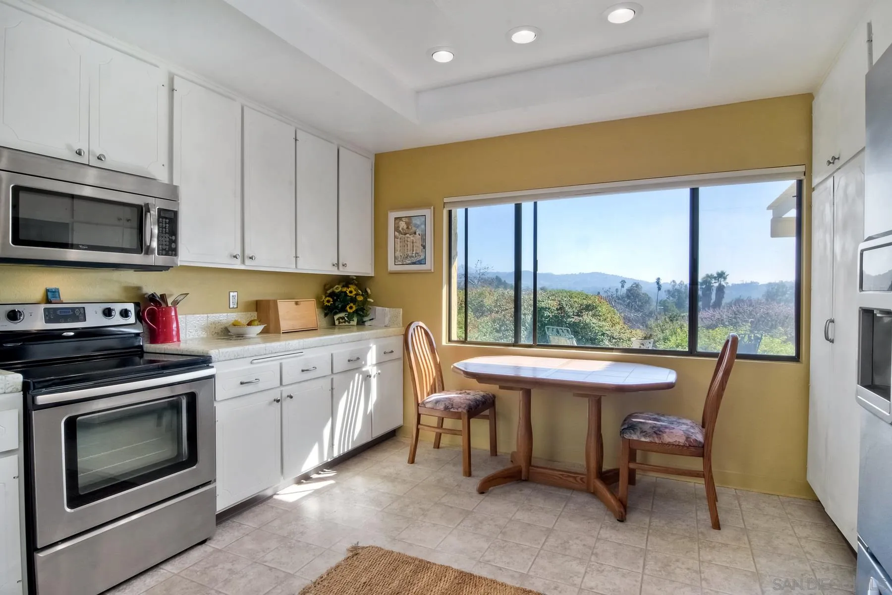13416 The Square Poway, CA 92064 - Photo 19 of 35 a kitchen with a stove a sink and a refrigerator