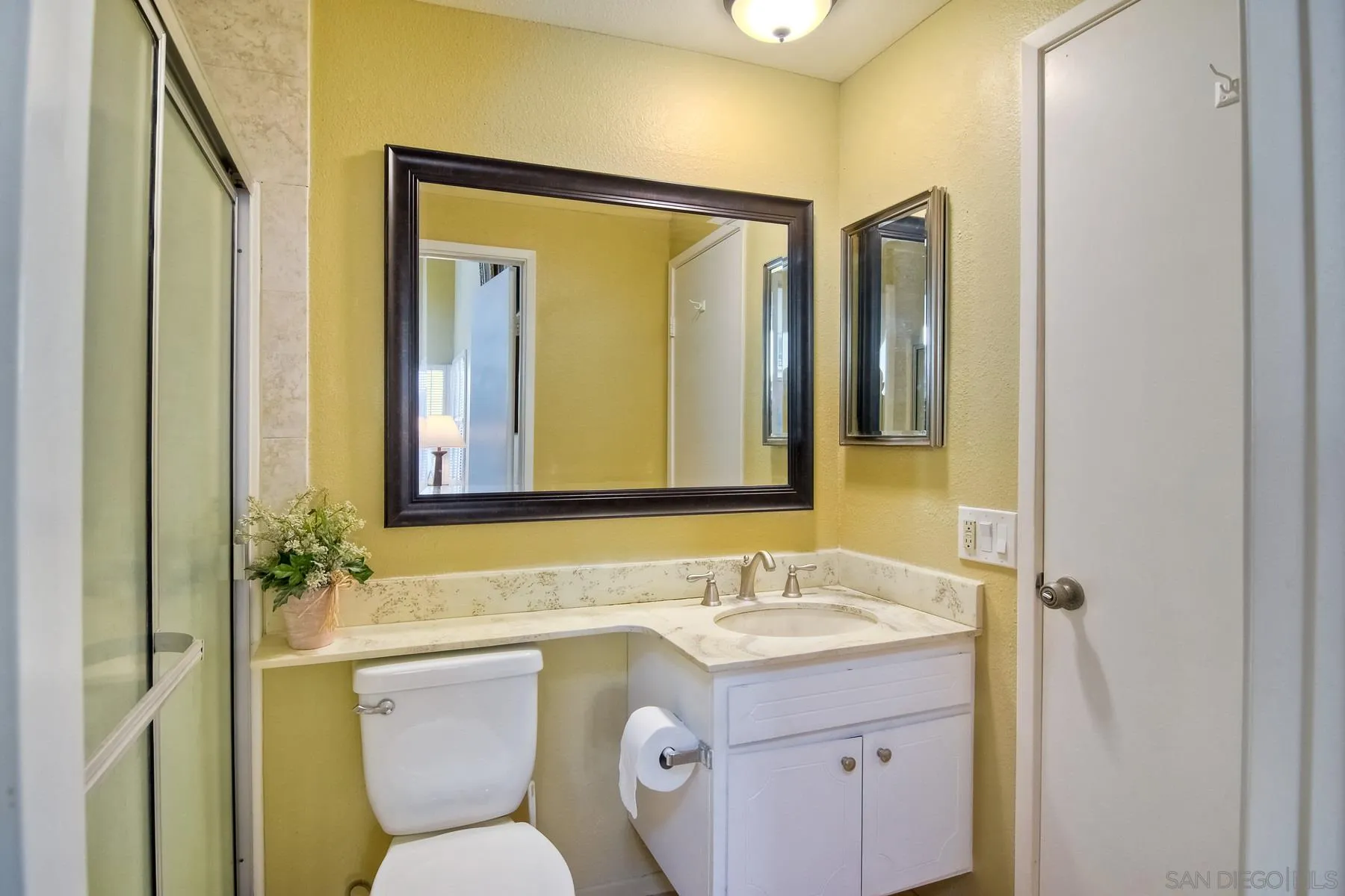 13416 The Square Poway, CA 92064 - Photo 30 of 35 a bathroom with a granite countertop sink toilet and mirror