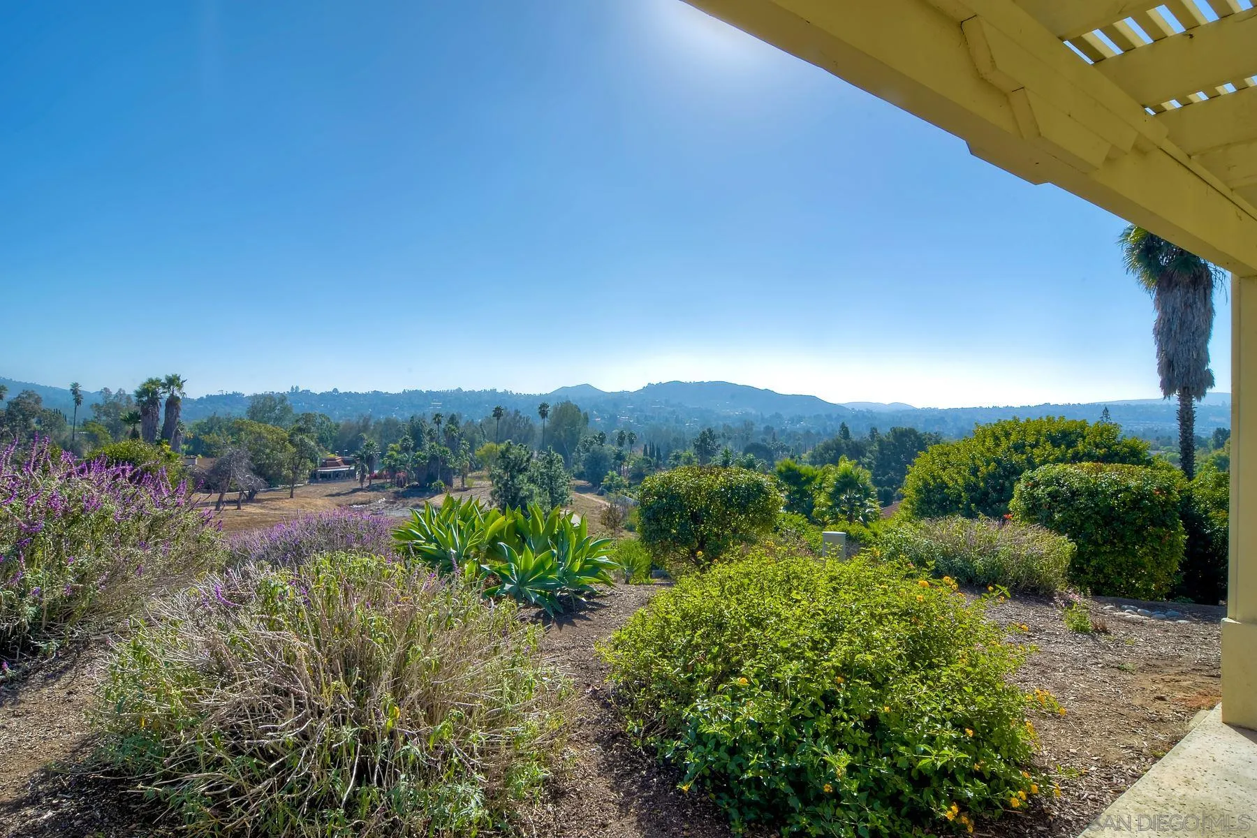 13416 The Square Poway, CA 92064 - Photo 7 of 35 a view of a garden with mountains in the background