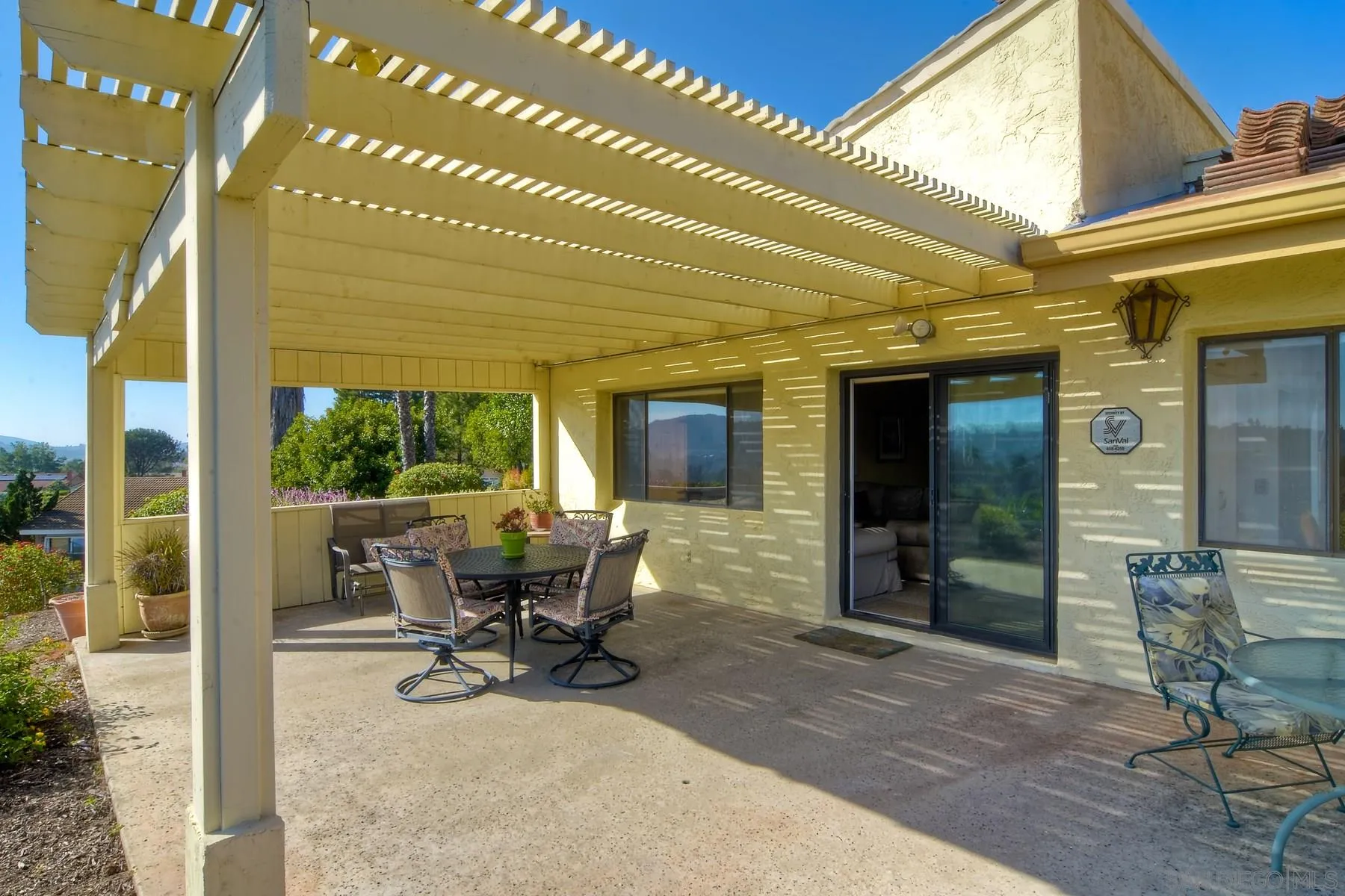 13416 The Square Poway, CA 92064 - Photo 8 of 35 a view of a patio with table and chairs and potted plants