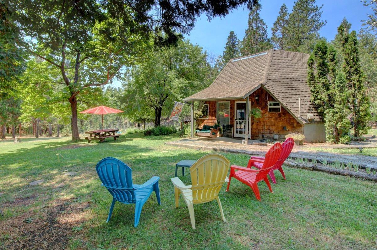 770 Hitching Post Road Grants Pass, OR 97526 - Photo 21 of 29 a view of a house with a yard chairs and table in the patio