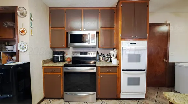 a kitchen with cabinets and steel stainless steel appliances