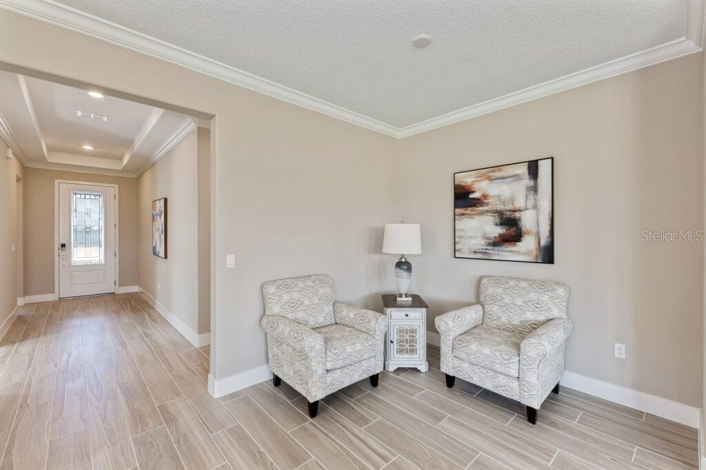 4529 Northwest 53rd Avenue Road Ocala, FL 34482 - Photo 3 of 17 a living room with furniture and a wooden floor