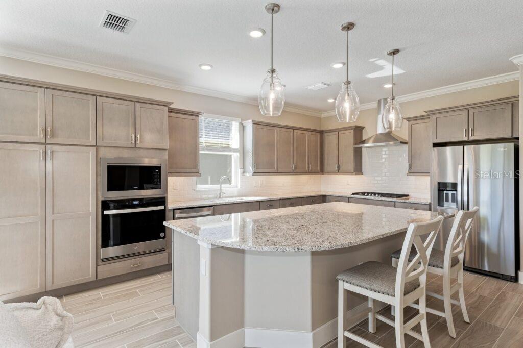 4529 Northwest 53rd Avenue Road Ocala, FL 34482 - Photo 6 of 17 a kitchen with a center island appliances and cabinets
