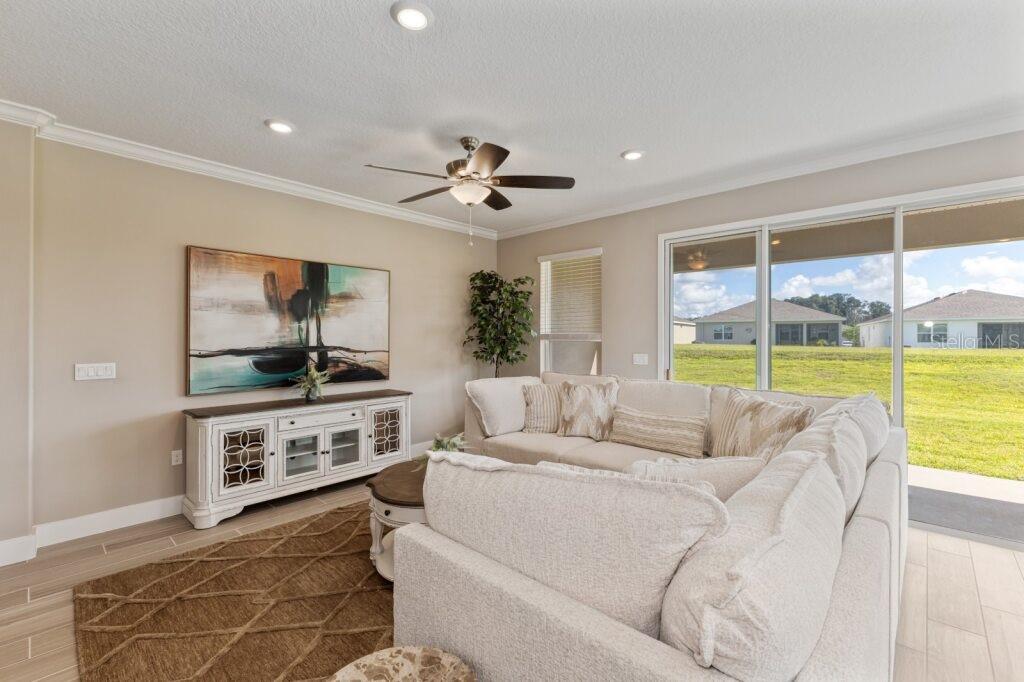 4529 Northwest 53rd Avenue Road Ocala, FL 34482 - Photo 7 of 17 a living room with furniture and a flat screen tv