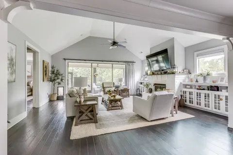 a backyard of a house with table and chairs