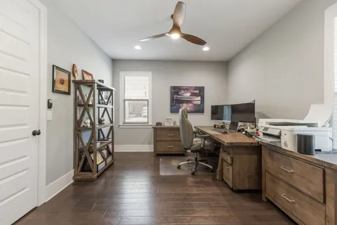 a bedroom with a bed a dresser and a flat screen tv