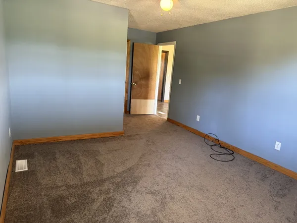 a view of a refrigerator in kitchen and wooden floor