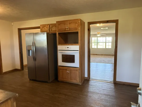 an empty room with windows and closet