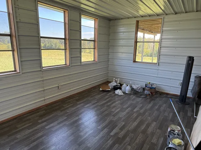 a view of a field of grass and trees