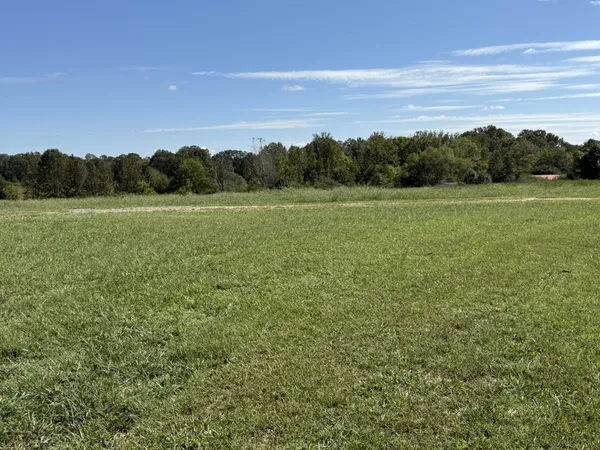 a backyard of a house with barbeque oven and outdoor seating