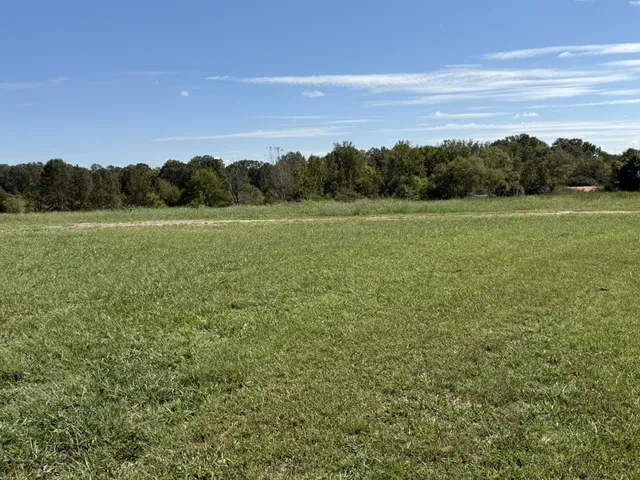 a backyard of a house with barbeque oven and outdoor seating