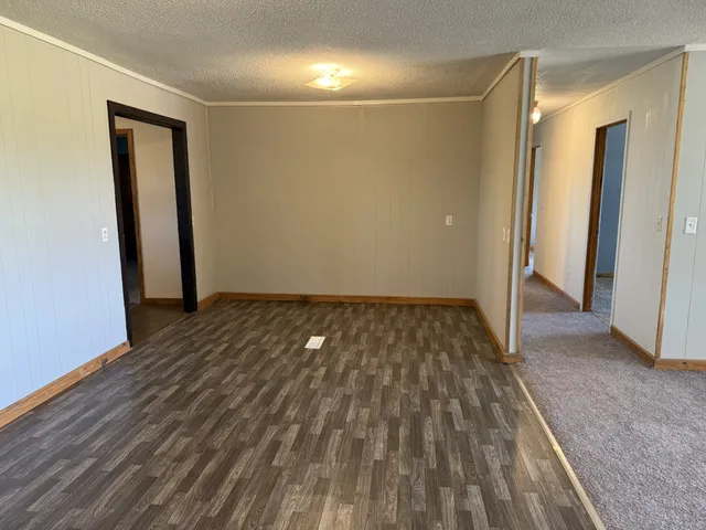 a view of a room with wooden floor and brick wall