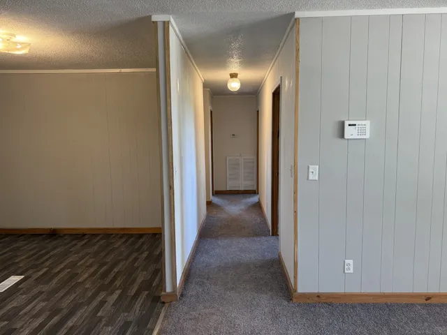 an empty room with windows and closet