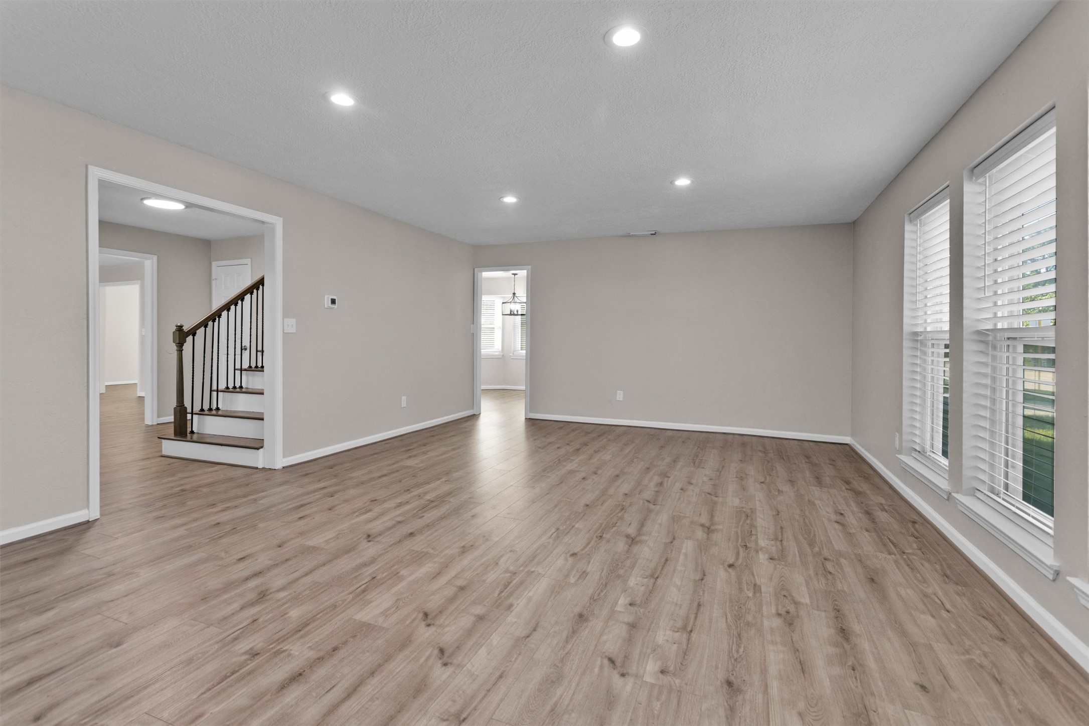 9115 Godstone Lane Spring, TX 77379 - Photo 7 of 46 a revere shot of the living space. The opening to the back leads to the breakfast nook and kitchen.