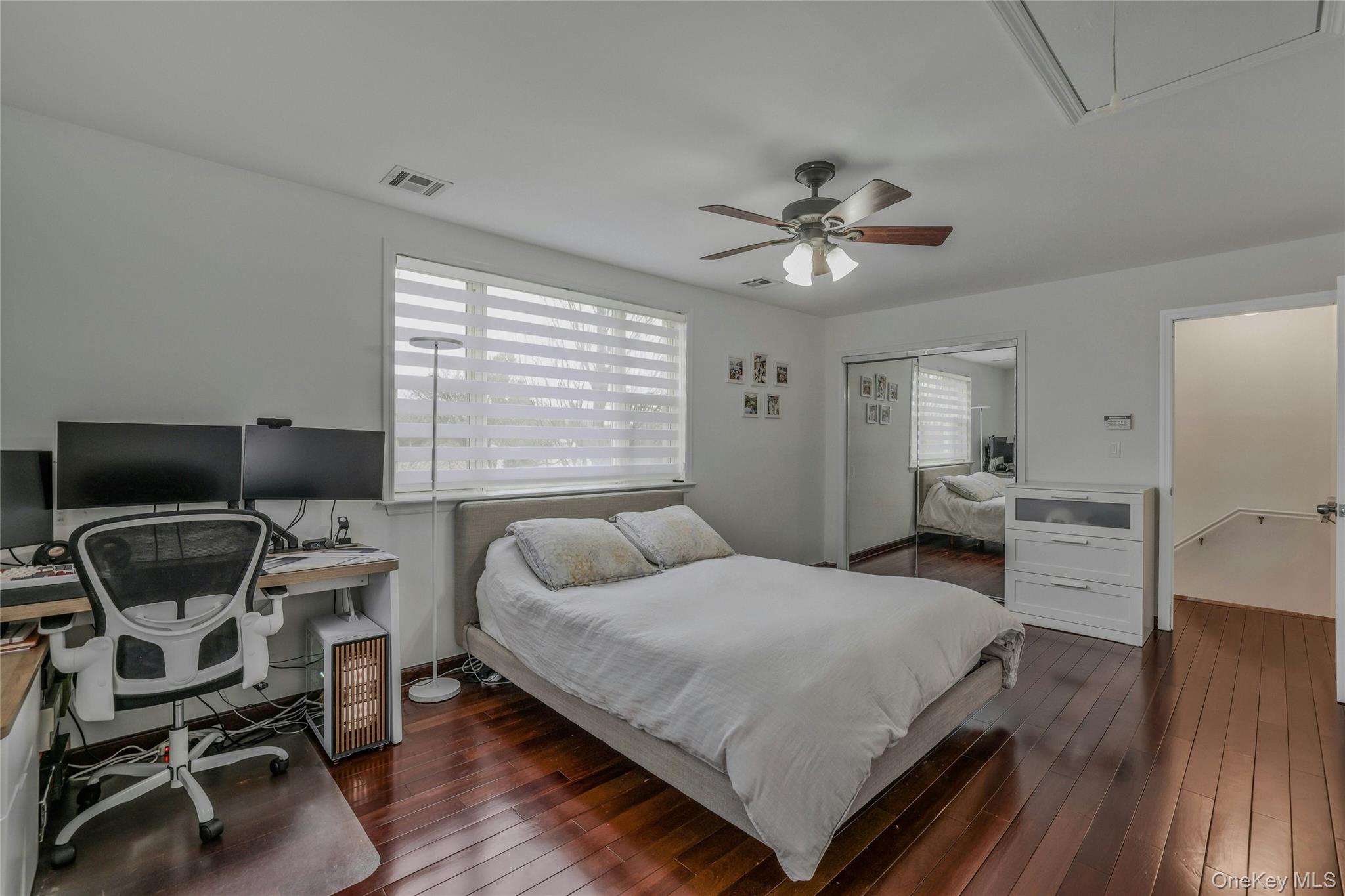 22904 67th Avenue, Unit 38 Queens, NY 11364 - Photo 12 of 17 a bedroom with a bed and chair