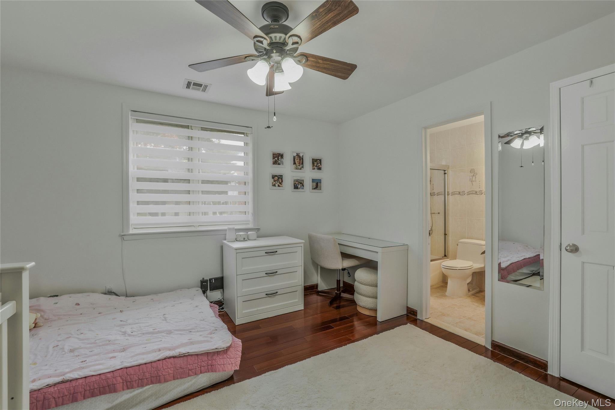 22904 67th Avenue, Unit 38 Queens, NY 11364 - Photo 14 of 17 a bedroom with a bed and a window