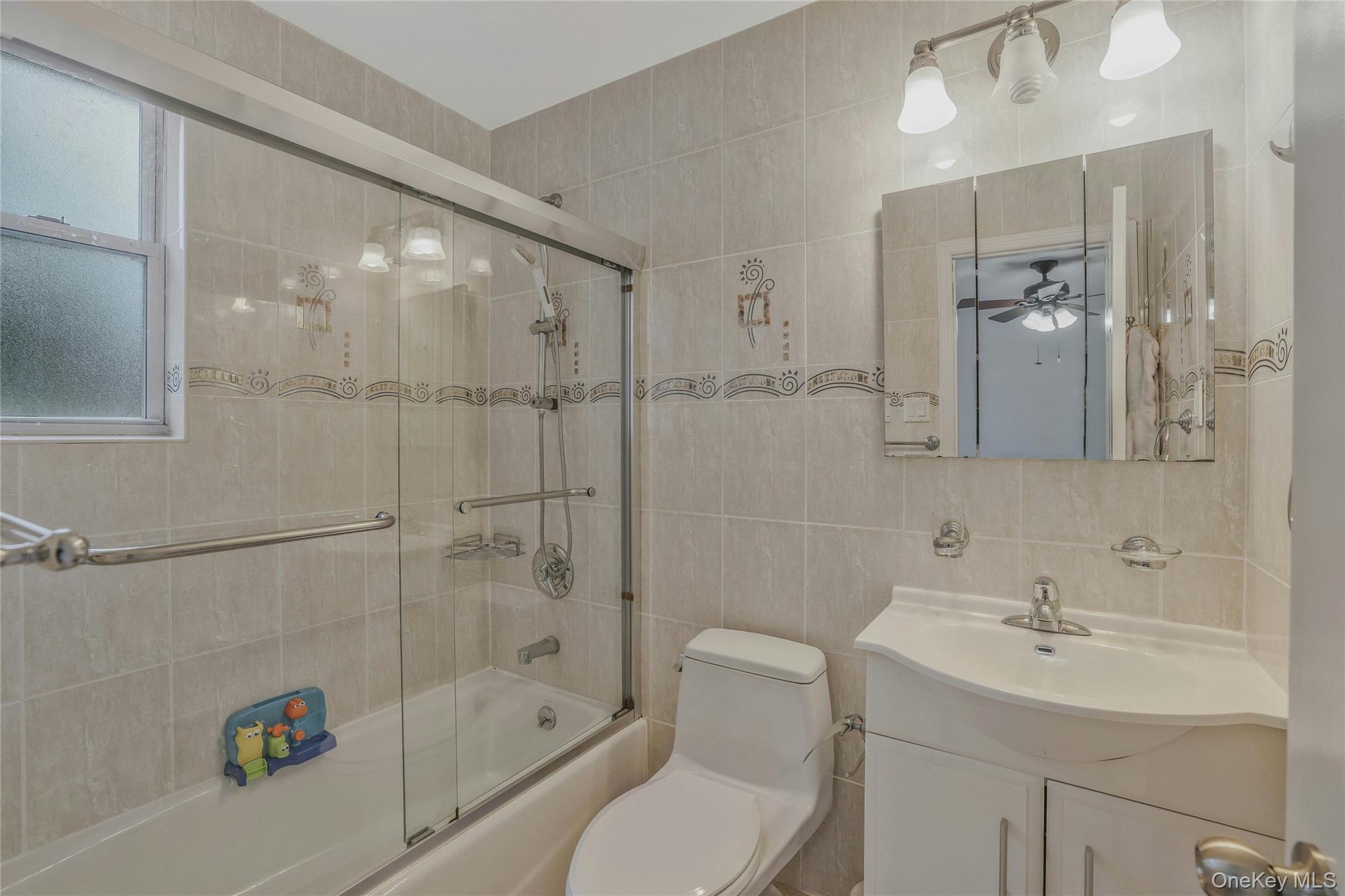 22904 67th Avenue, Unit 38 Queens, NY 11364 - Photo 15 of 17 a bathroom with a sink toilet and shower