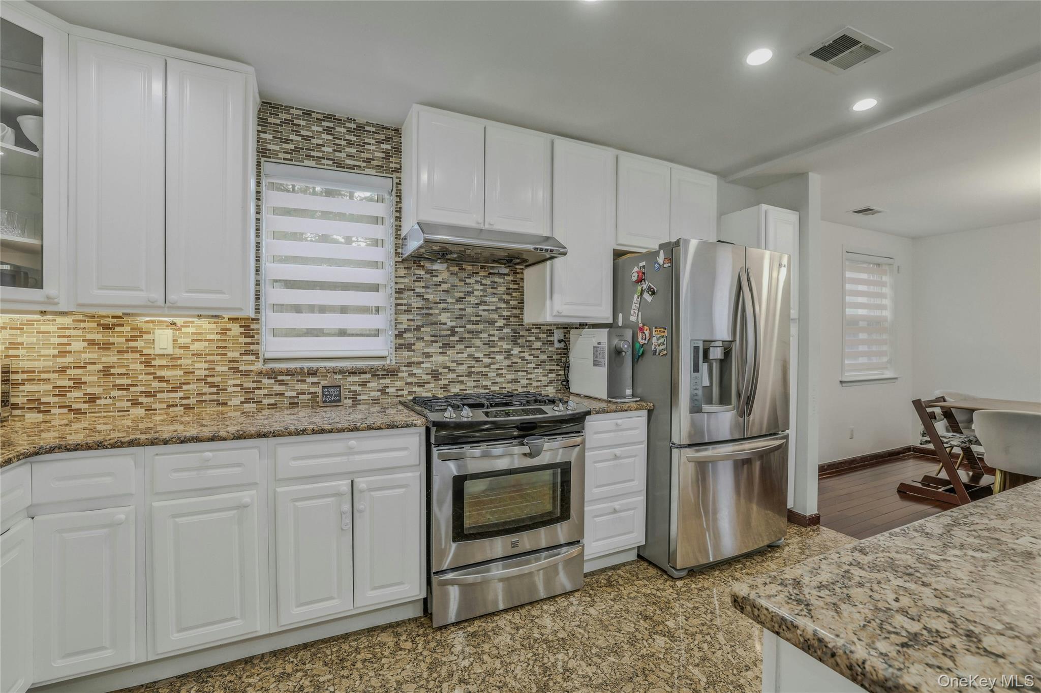 22904 67th Avenue, Unit 38 Queens, NY 11364 - Photo 5 of 17 a kitchen with stainless steel appliances granite countertop a refrigerator stove and sink