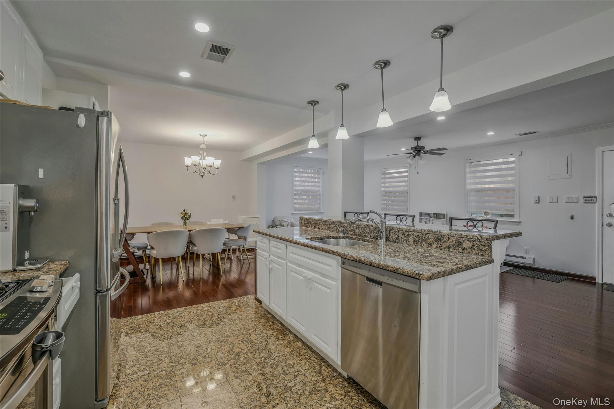 22904 67th Avenue, Unit 38 Queens, NY 11364 - Photo 7 of 17 an open kitchen with a sink and breakfast area